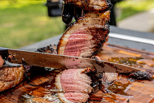 Certified ONYA® beef picanha cooked to medium rare and sliced thin for serving. The tender juicy picanha steak is skewered in the shape of a half moon in the traditional Brazilian style of preparing this cut of beef