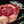 Certified ONYA® Tomahawk Ribeye photographed raw with beautiful marbling. Shown with garnishes including sea salt and rosemary. Incredibly tender steak