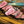 Beef filet mignon cooked to medium rare and sliced on a wooden cutting board, exposing the tender interior of this Certified ONYA® filet mignon 