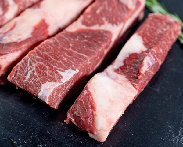 Certified ONYA® Beef short ribs cut into sections ready for smoking and cooking in a pellet grill or smoker grill.